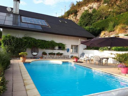 a swimming pool in front of a house at L'ermitage in Chambéry
