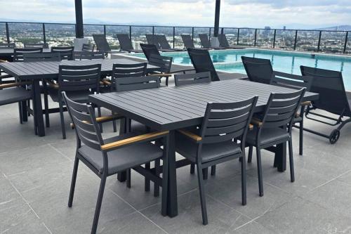 a group of tables and chairs on a roof at Modernidad, Comodidad y Acogedor in Guadalajara