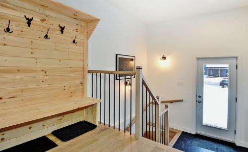 a staircase in a home with a wooden wall at 102 chemin des Ruisselets in Stoneham