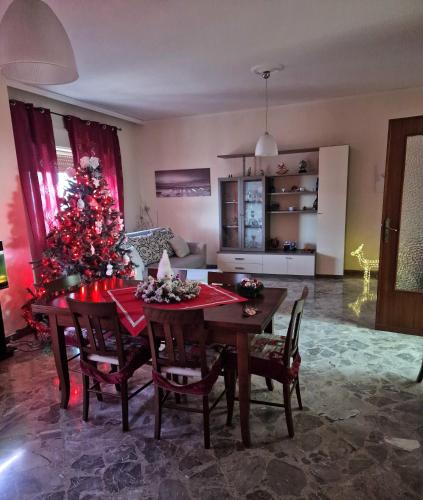 a living room with a christmas tree and a table at B&B da Giovy in Marsala