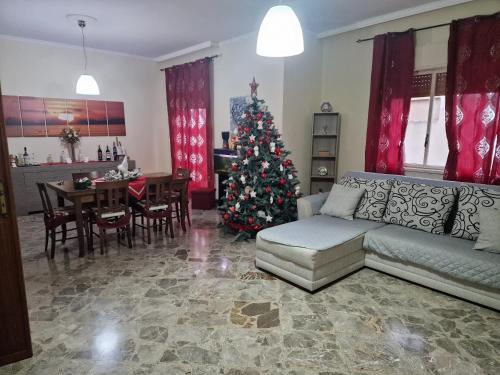 a living room with a christmas tree and a couch at B&B da Giovy in Marsala