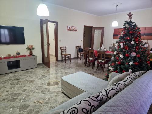a living room with a christmas tree in it at B&B da Giovy in Marsala