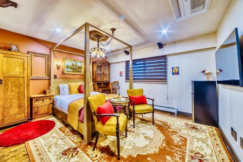 a bedroom with a bed and a table and chairs at Neocolonial Nouveau Kensington Vacation Home in Vancouver