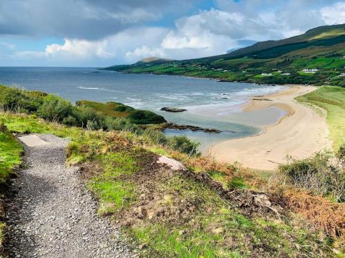 a view of a beach with mountains in the background at Cosy Studio Cabin set in nature with stove in Killybegs