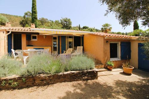 une maison avec une table et des chaises devant dans l'établissement Mazet Mireille climatisé pour 4 personnes avec tennis et piscine à La Londes-Les-Maures, à La Londe-les-Maures