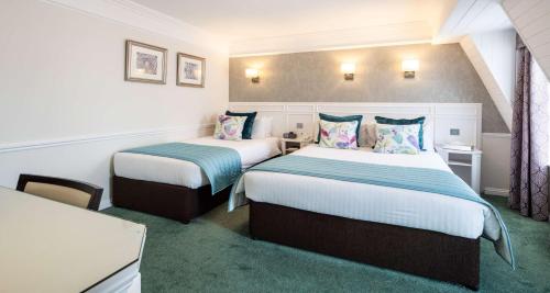 a hotel room with two beds in a room at Best Western Royal Hotel in Saint Helier Jersey