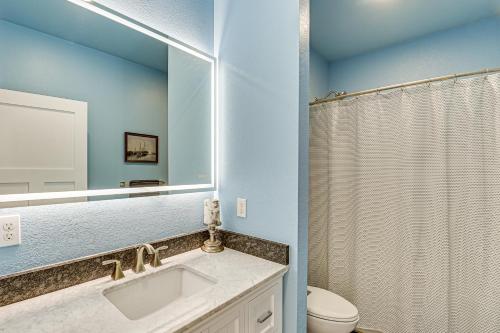 a bathroom with a sink and a toilet and a mirror at Modern and Spacious Luxe Home in Remote Fort Peck! in Park Grove