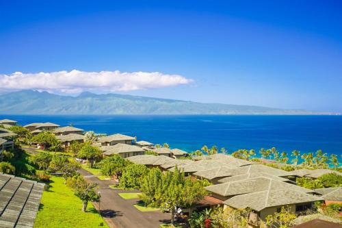 a row of houses with the ocean in the background at 1722 Ridge in Kahana