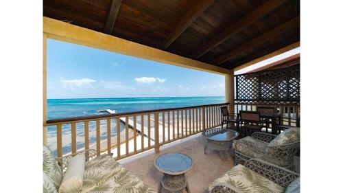 a balcony with a view of the ocean at Residences at Barrier Reef 1-2C Oceanfront 2 BR by Stay Floreo in San Pedro