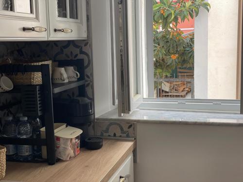 a kitchen with a window and a counter top at Casa 99 in Amendolara