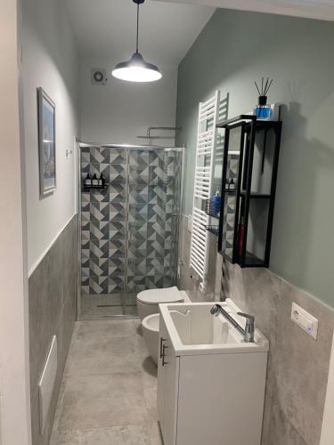 a bathroom with a sink and a toilet and a shower at Casa 99 in Amendolara