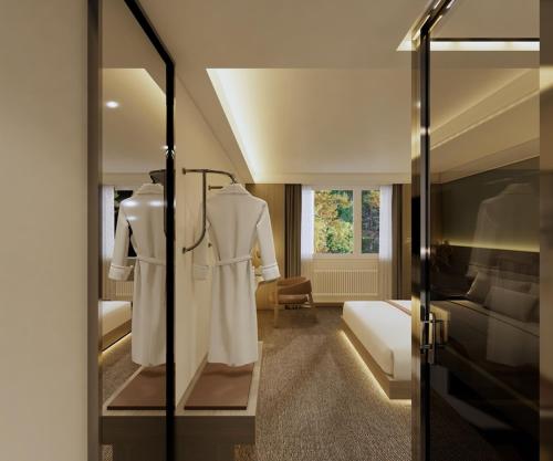 a room with a robe and a bed and a mirror at Berghof am See in Langelsheim