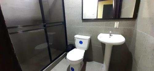 a bathroom with a toilet and a sink at Natural Manzanillo in Manzanillo