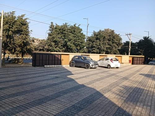 two cars parked in a parking lot at Best Western Swaran Amritsar in Amritsar