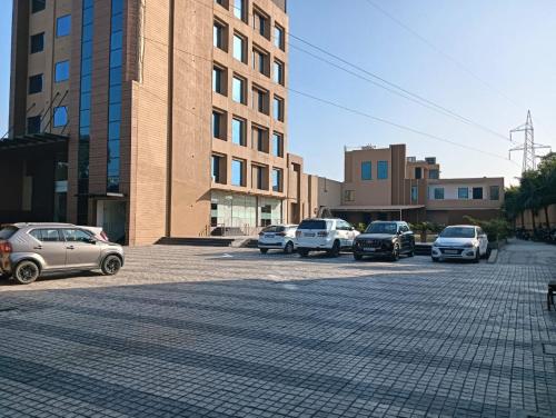 a group of cars parked in a parking lot at Best Western Swaran Amritsar in Amritsar