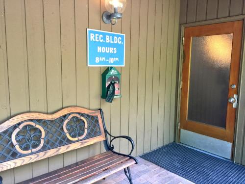 a bench sitting in front of a house with a door at Snowater Condo 57 - A Great 2-Story Family Condo That Sleeps 6 in Glacier