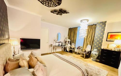 a bedroom with a large bed and a living room at Luxury City Center apartment with Canal view 1 kingsize bed and 1 sleeping sofa in Amsterdam
