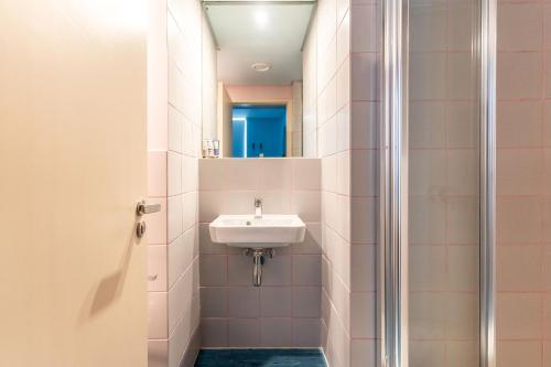 a bathroom with a sink and a mirror at The Tropicana Hotel in Cape Town