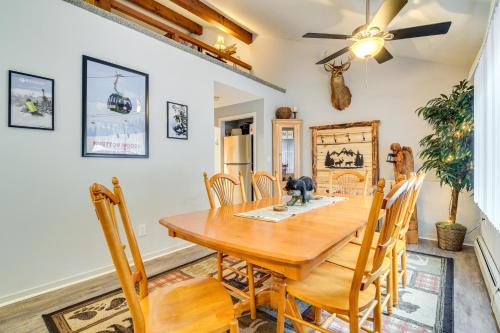 a dining room with a wooden table and chairs at Cozy Bartlett Condo with Deck and Resort Amenities! in Bartlett