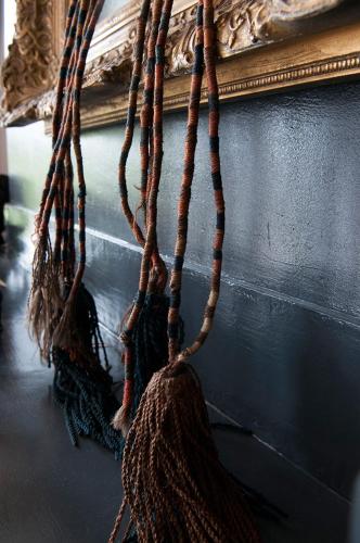 a bunch of ropes hanging from a wall at RiverSide Suite - Haarlem City Centre in Haarlem