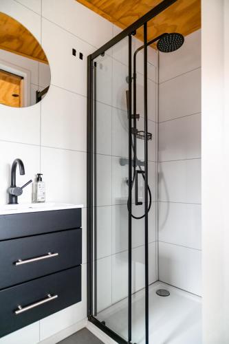 a glass shower in a bathroom with a sink at Boshuisje Zelhem in Zelhem