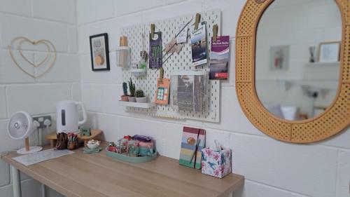 a vanity with a mirror and a table with a mirror at The Nest Number 3 in Rosslare Harbour