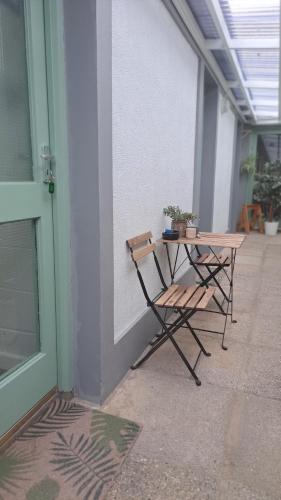 a table and two chairs next to a wall at The Nest Number 3 in Rosslare Harbour