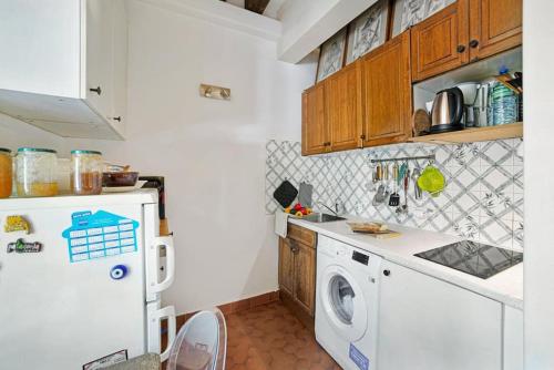 une cuisine avec un lave-linge et un réfrigérateur dans l'établissement Artistic apartment in Paris 12, à Paris