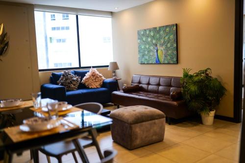 a living room with a couch and a table at Suite Luxury en Puerto Santana in Guayaquil