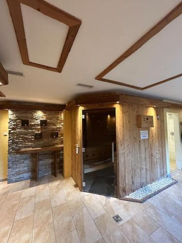 an empty room with a stone wall and a ceiling at Chalet im Wanderparadies in Annaberg im Lammertal