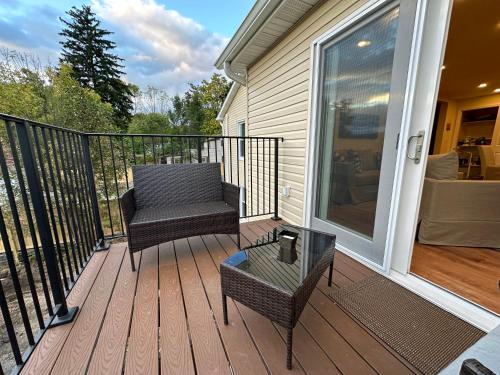 a porch with a chair and a table on it at Saugerties Waterfront Getaway in Saugerties