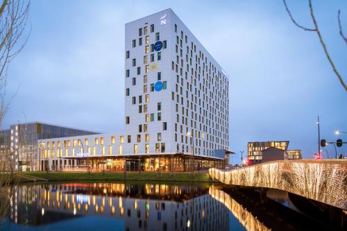 
a large building with a clock on the side of it at Novotel Amsterdam Schiphol Airport in Hoofddorp
