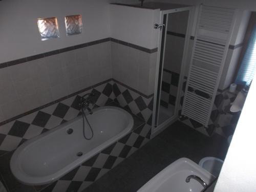 a bathroom with a bath tub and a sink at B&B Borgo Valagnesi casa Annarita in Pratovecchio