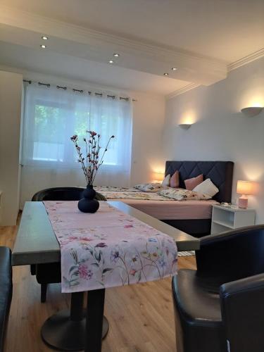a living room with a table and a bed at Vila Ema Apartments and Rooms in Ljubljana