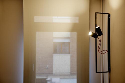 a room with a window with a light on the wall at Smart Hotel in Carpi