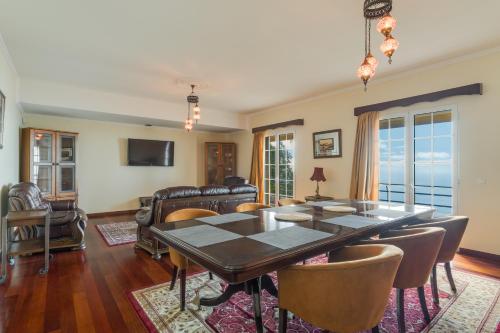 a dining room with a table and chairs at Villa Nobrega by Holiday Rental Madeira in Funchal