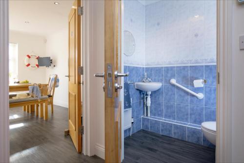 a bathroom with a toilet and a sink at Anchors Away in Exmouth