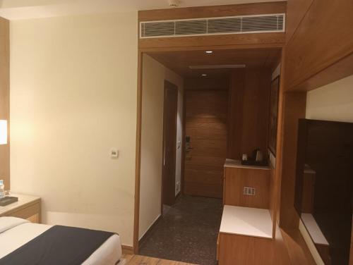 a hotel room with a bed and a air conditioner at Best Western Swaran Amritsar in Amritsar