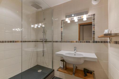 a bathroom with a sink and a shower at Chalet le Regain in Villard-Reculas