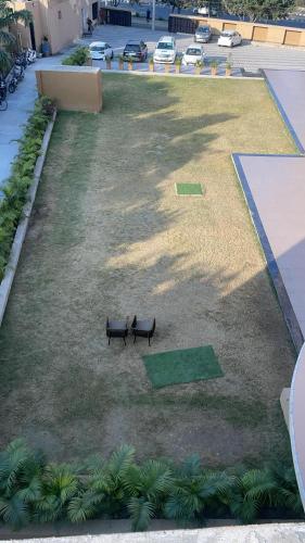 a park with two benches in the grass at Best Western Swaran Amritsar in Amritsar