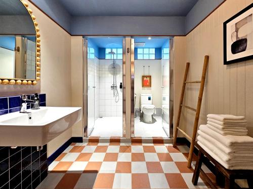 a bathroom with a shower and a sink and a toilet at Blu Dock Restel Bangkok in Bangkok