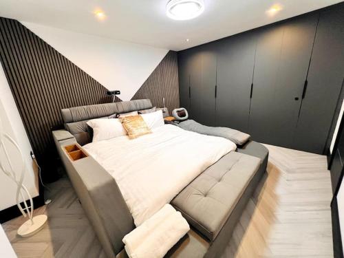 a bedroom with a large bed and a couch at Bel Casa Solihull in Solihull