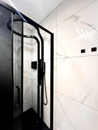 a shower with a glass door in a bathroom at Bel Casa Solihull in Solihull