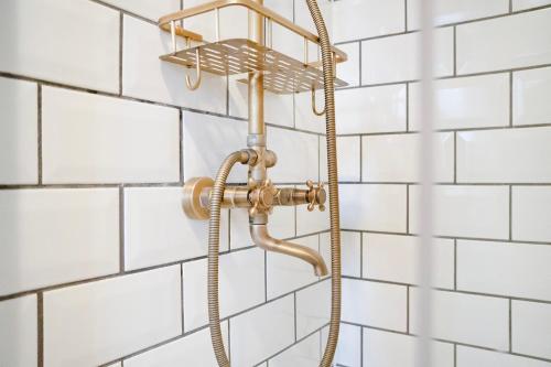 a shower in a bathroom with white tiles at NEW! 2BR in Richard Street in Hetton le Hole