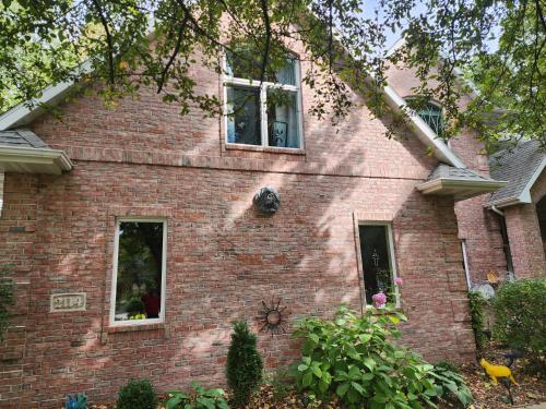 a red brick house with two windows on it at Simon in Kaukauna