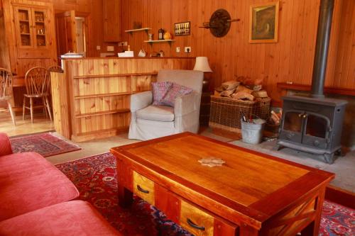 a living room with a couch and a stove at The Coach House in Lochailort