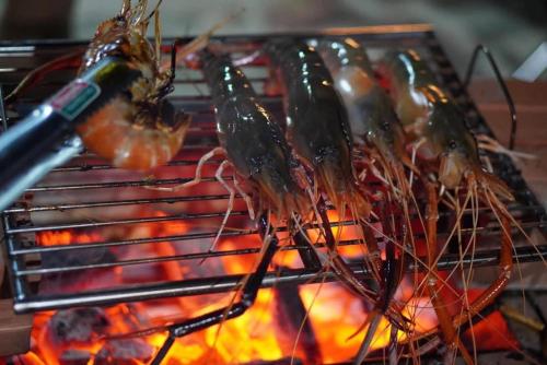 a bunch of food cooking on a grill at Damboung Bungalow in Kampot
