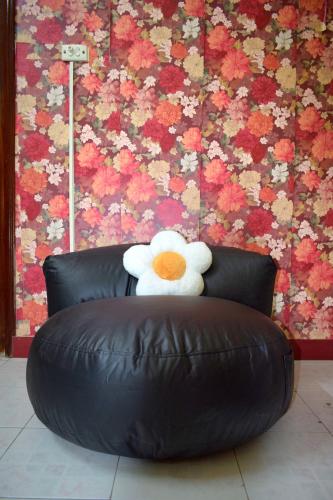 a stuffed teddy bear sitting on top of a leather couch at LushStay Hanoi Train Street - Cozy in Hanoi
