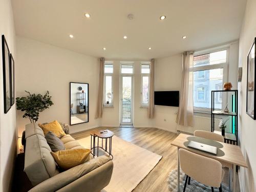 a living room with a couch and a table at Harmony Home - inkl Balkonen - TV Streaming - uvm in Bremerhaven
