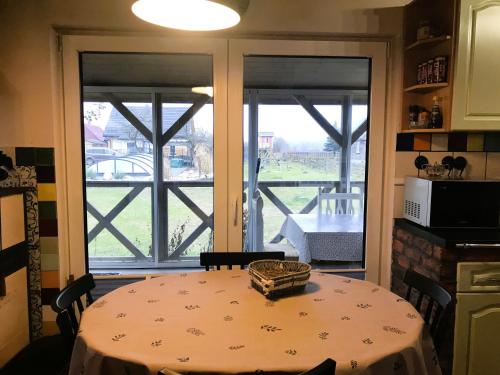 a dining room with a table and a window at Domek Walentinki in Rogacze